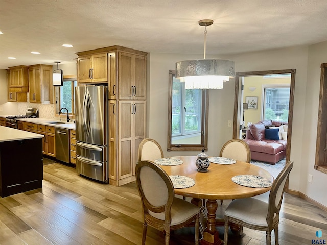 dining room featuring light hardwood / wood-style floors and sink