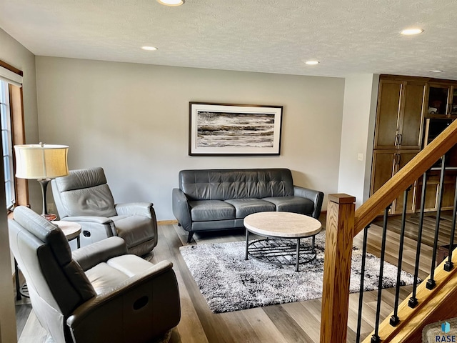 living room featuring hardwood / wood-style floors and a textured ceiling