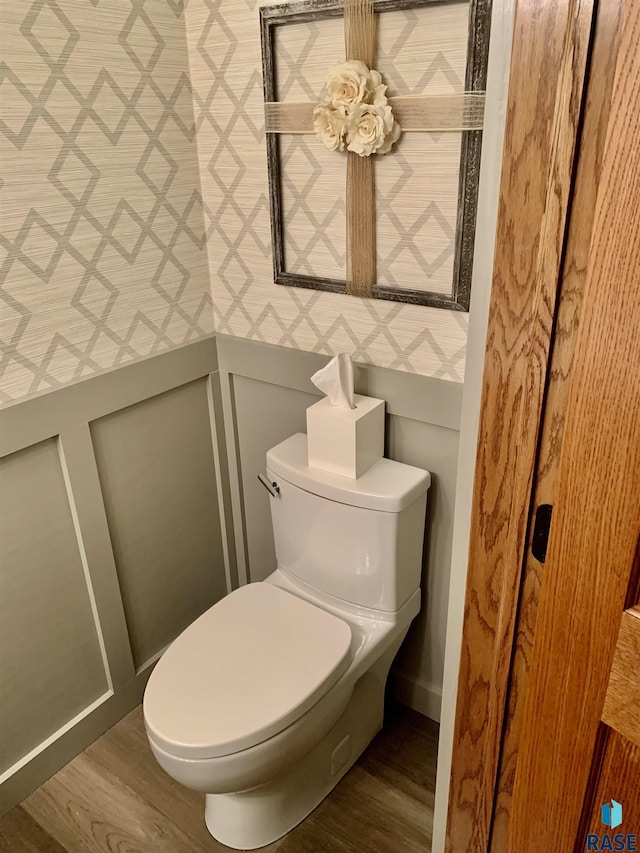 bathroom featuring wood-type flooring and toilet