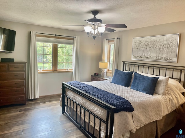 bedroom featuring hardwood / wood-style floors, a textured ceiling, and ceiling fan