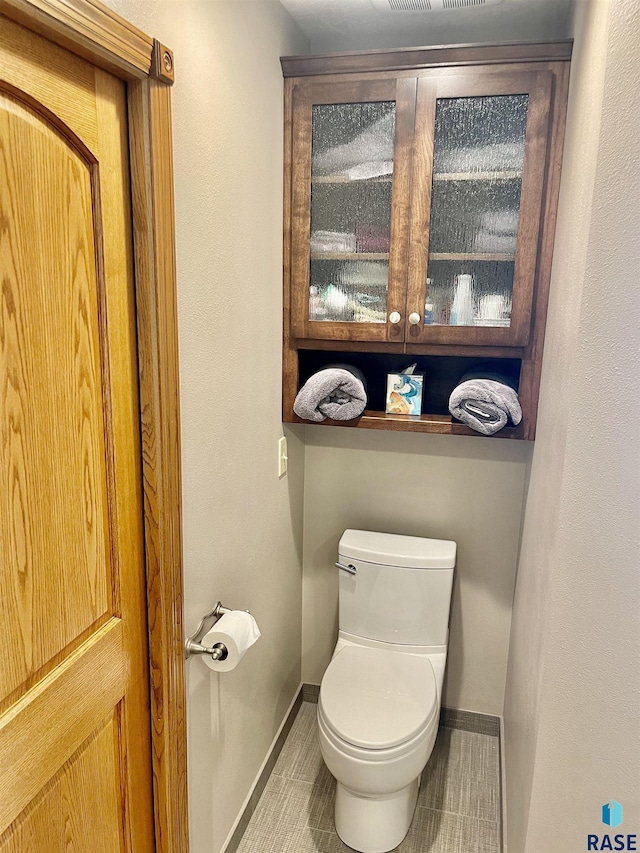 bathroom with tile patterned flooring and toilet