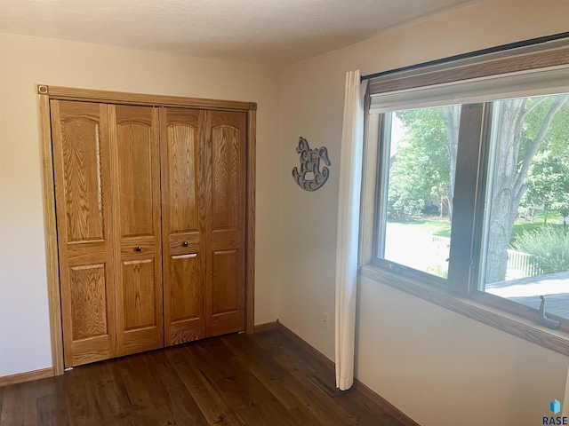 unfurnished bedroom featuring dark hardwood / wood-style flooring