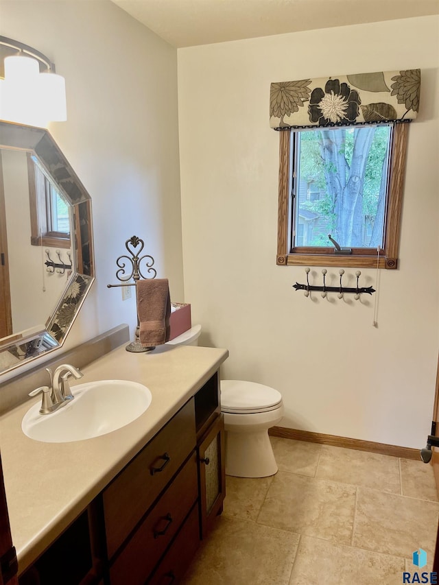 bathroom featuring vanity and toilet