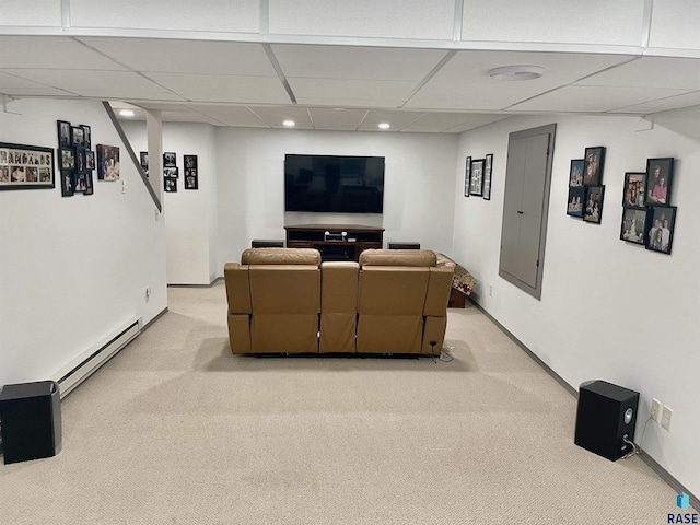 home theater room with a paneled ceiling, electric panel, carpet floors, and a baseboard heating unit