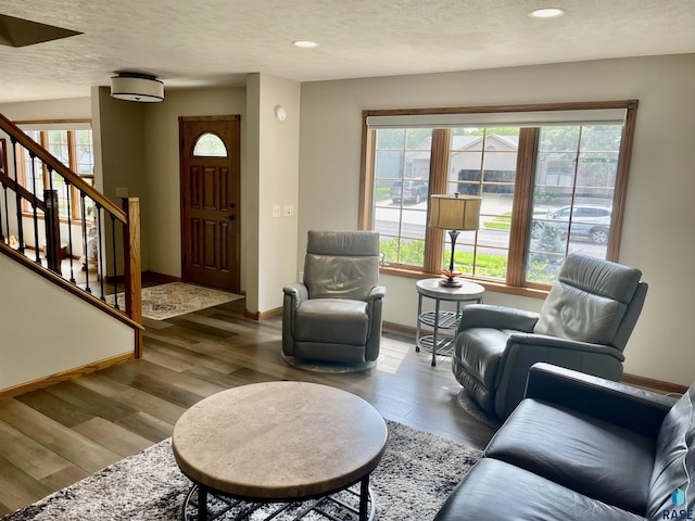 living room featuring plenty of natural light, hardwood / wood-style floors, and a textured ceiling