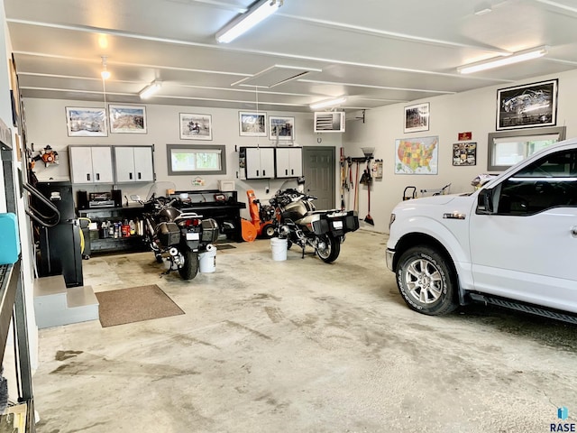 garage featuring a wall unit AC