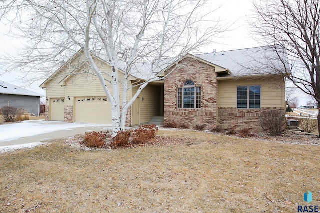 view of front of house featuring a garage and a front lawn