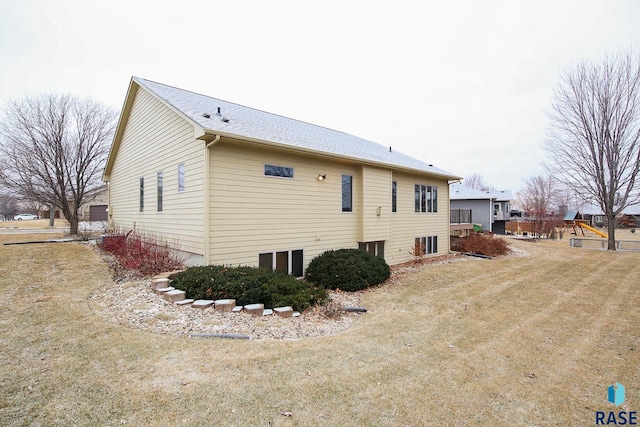 view of side of home with a yard