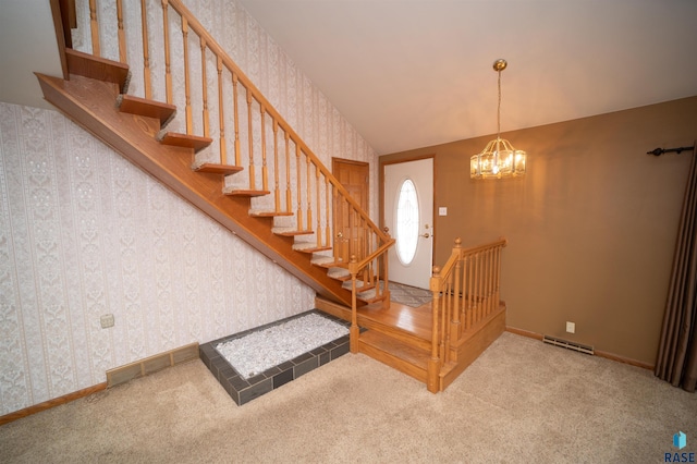 carpeted foyer entrance featuring a chandelier