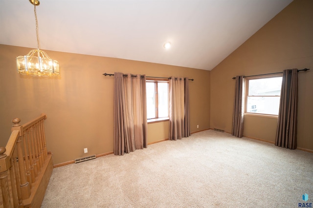 unfurnished room with carpet floors, a chandelier, and lofted ceiling