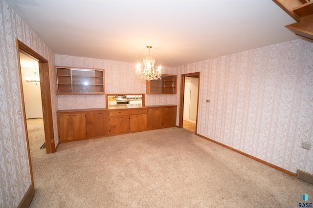 unfurnished living room with light colored carpet and a chandelier