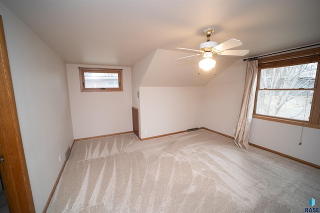 bonus room featuring ceiling fan, lofted ceiling, and light carpet