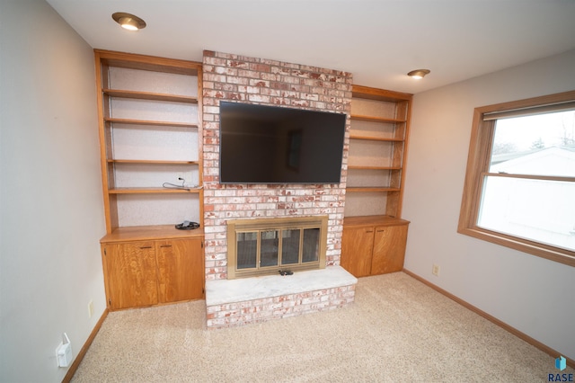 unfurnished living room with light carpet and a fireplace