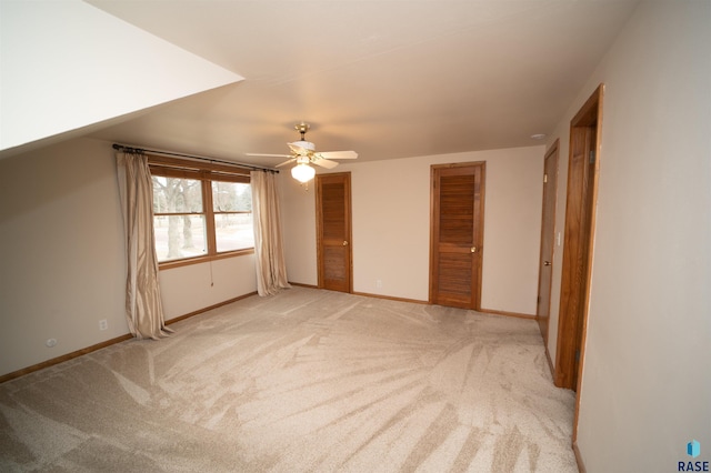 unfurnished bedroom featuring ceiling fan and light colored carpet