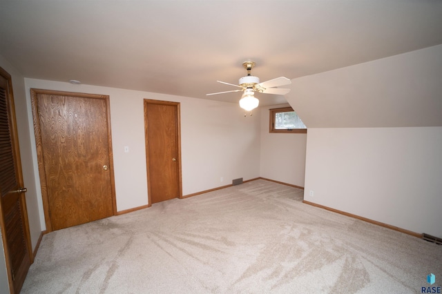 additional living space with ceiling fan, lofted ceiling, and light carpet