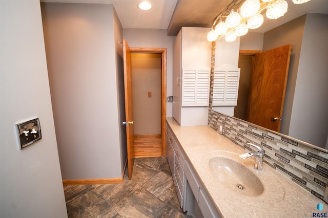 bathroom with decorative backsplash and vanity