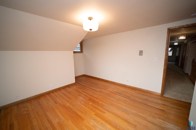 bonus room with light hardwood / wood-style flooring and vaulted ceiling