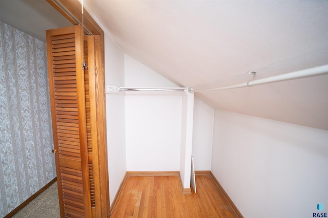 spacious closet featuring wood-type flooring and vaulted ceiling