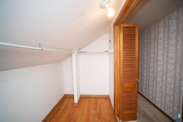 walk in closet with vaulted ceiling and light wood-type flooring