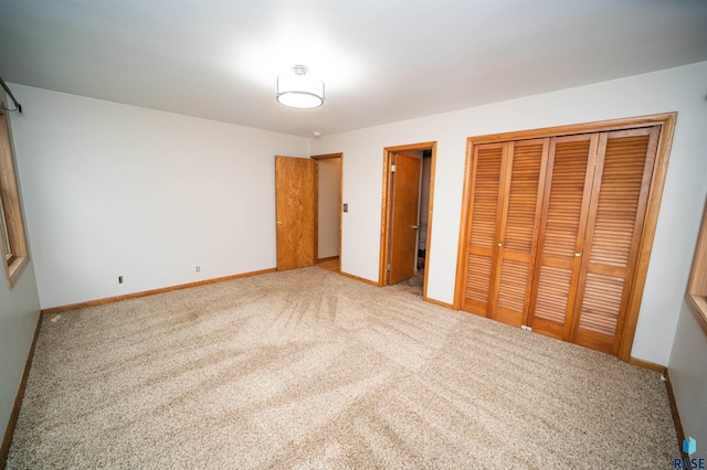 unfurnished bedroom with light carpet and a closet