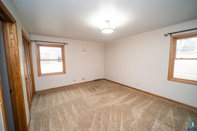 carpeted spare room with plenty of natural light