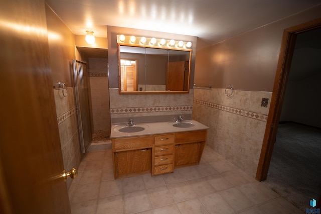 bathroom with tile patterned flooring, vanity, and tile walls