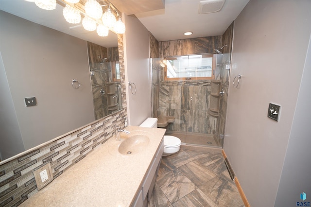 bathroom featuring vanity, backsplash, toilet, and walk in shower