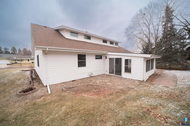 rear view of property with a lawn