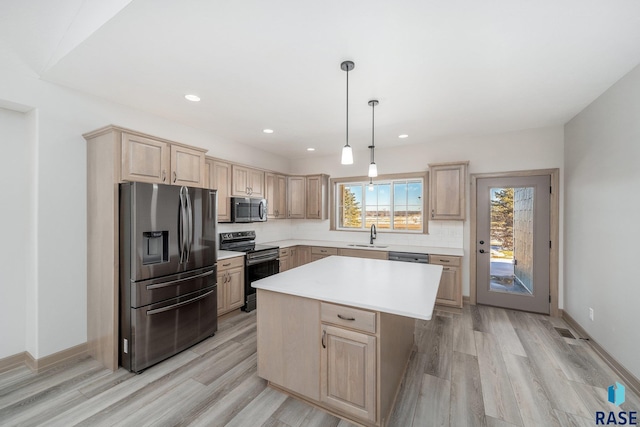 kitchen with pendant lighting, a center island, decorative backsplash, light brown cabinetry, and appliances with stainless steel finishes