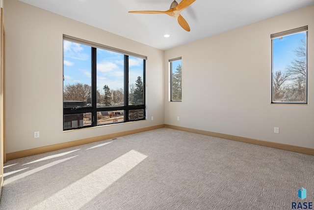 unfurnished room with carpet floors, baseboards, a ceiling fan, and recessed lighting