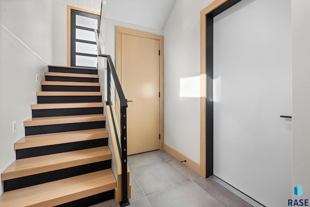 staircase featuring tile patterned floors