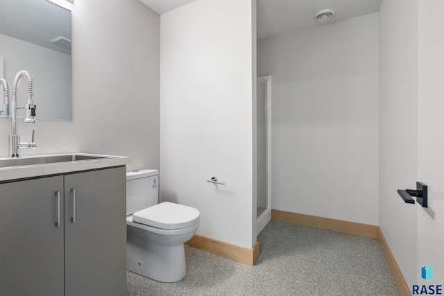 bathroom featuring a shower stall, baseboards, vanity, and toilet