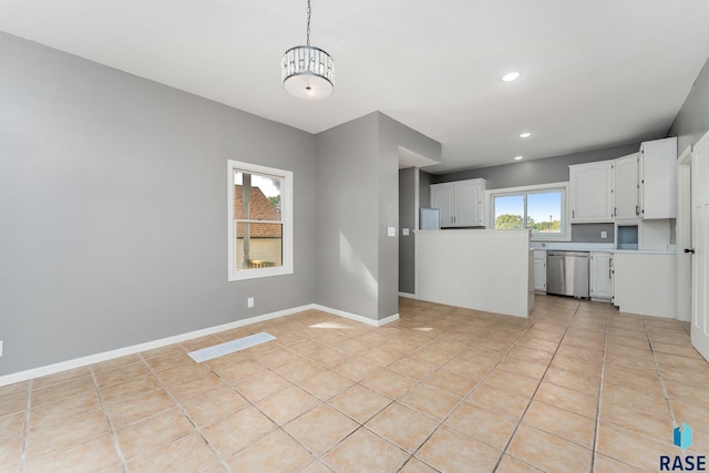 kitchen featuring dishwasher, white cabinetry, hanging light fixtures, and light tile patterned floors