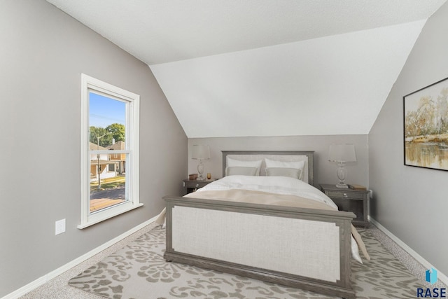 carpeted bedroom featuring vaulted ceiling