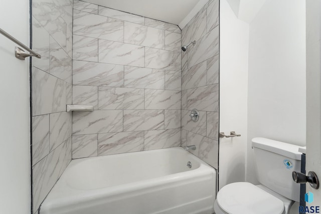 bathroom featuring tiled shower / bath and toilet