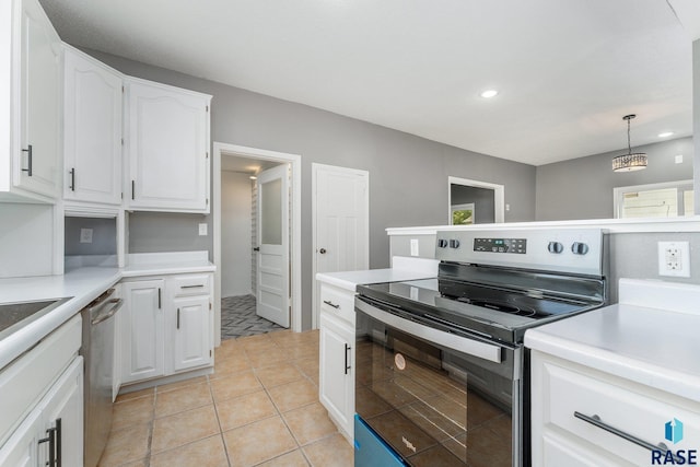 kitchen featuring white cabinets, light tile patterned flooring, hanging light fixtures, and appliances with stainless steel finishes