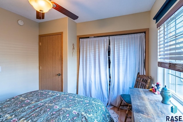 bedroom with ceiling fan and hardwood / wood-style flooring