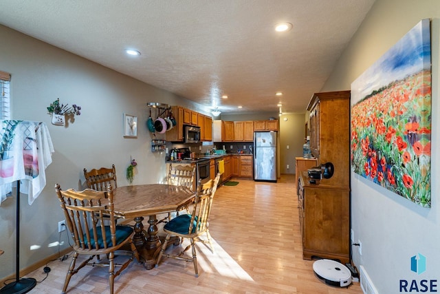 dining space with light wood-type flooring