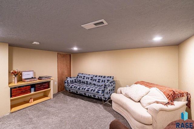 carpeted living room featuring a textured ceiling