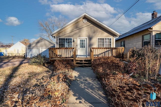 exterior space with a garage, an outdoor structure, and a deck