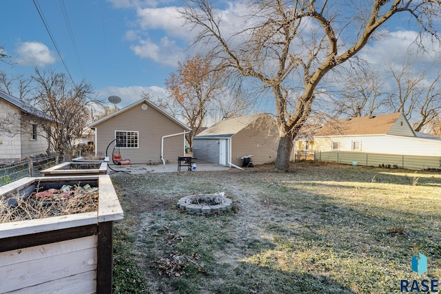 back of property with a fire pit, an outdoor structure, and a yard