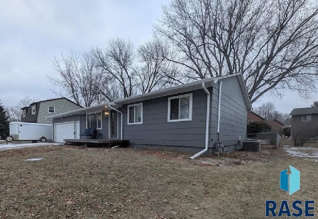 view of front of property with a front lawn and a garage