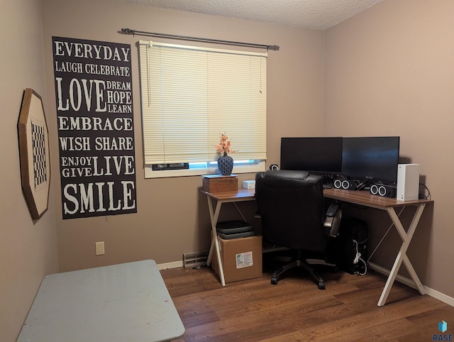 home office featuring a textured ceiling and hardwood / wood-style flooring