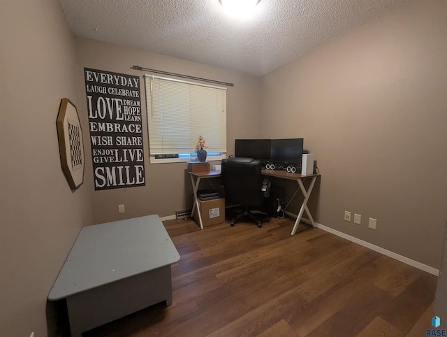 home office with dark hardwood / wood-style flooring and a textured ceiling