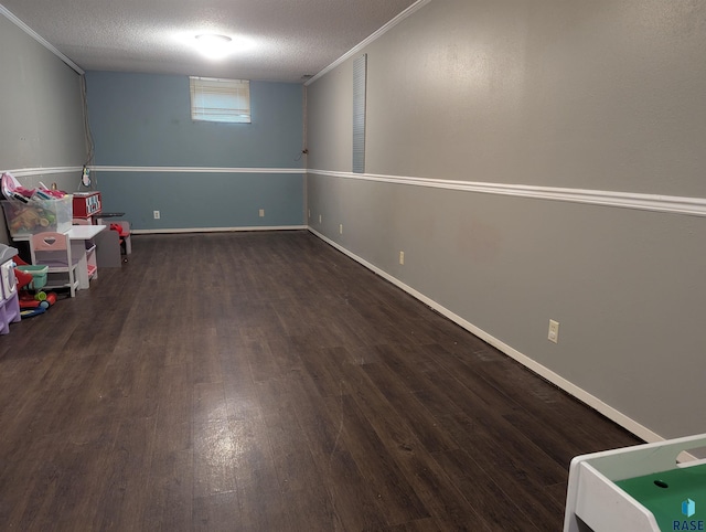 game room with a textured ceiling and dark wood-type flooring