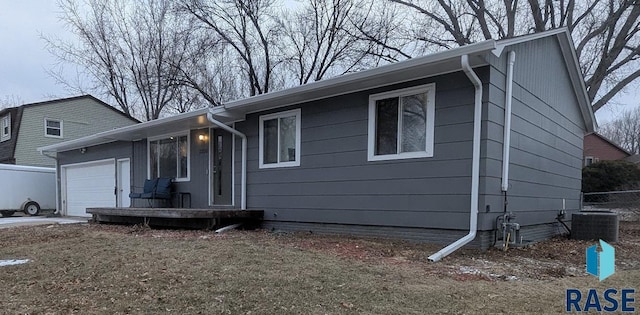 view of front of house featuring a garage and central air condition unit