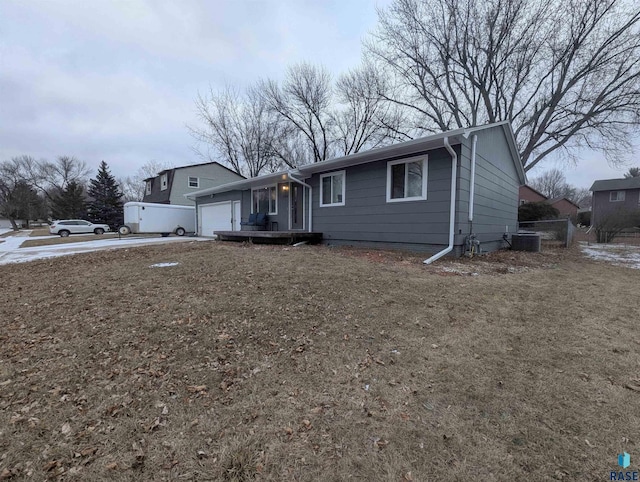 view of front of house featuring central AC and a garage