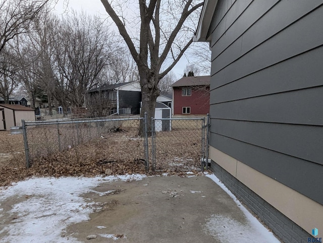 yard covered in snow with a shed