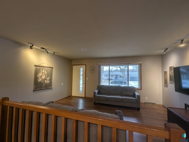 living room with hardwood / wood-style floors and rail lighting