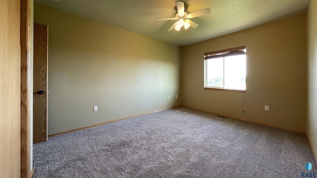 spare room featuring carpet flooring and ceiling fan